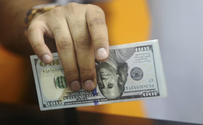 Battered dollar steadies after Trump triggers rout